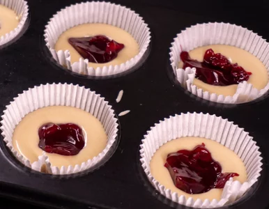 Miniatura: Do muffinek wkładam łyżeczkę dżemu....